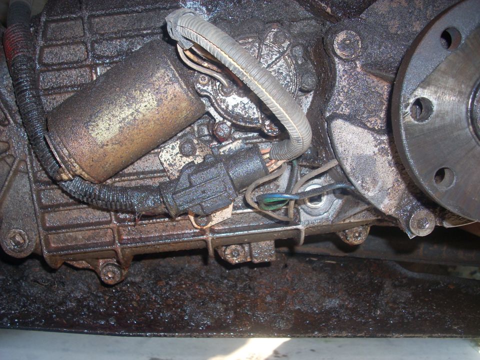 close-up of a dirty transfer case actuator with wires