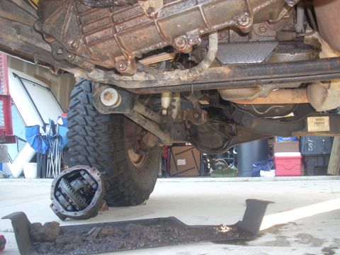 1992 Ford Bronco - Undercarriage view of a vehicle, showing a disassembled transfer case and differential.