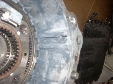 1992 Ford Bronco - A close-up view of a vehicle's transfer case component, showing internal gears and housing.