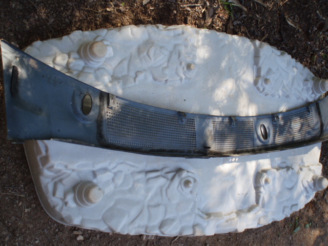 Windshield cowl grille on a textured surface