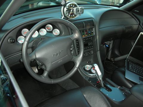 1998 Ford Crown Victoria - Customized car interior a large tachometer, multiple gauges, and a laptop, suggesting performance modifications.