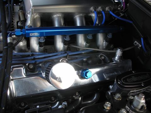 1998 Ford Crown Victoria - Custom engine components are visible, including a blue fuel rail and chrome valve covers with a Wilwood reservoir.