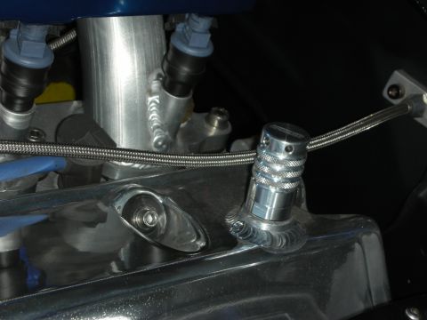 1998 Ford Crown Victoria - Engine bay detail shows a chrome radiator cap with a braided hose connection.