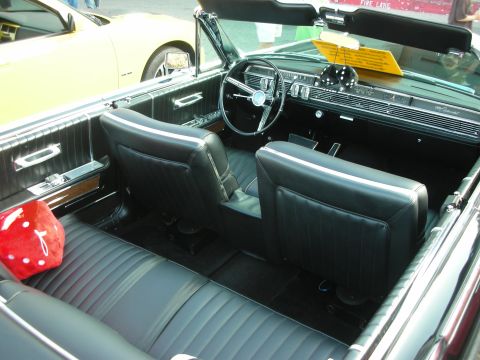 1998 Ford Crown Victoria - Interior view of a classic black convertible, with a yellow car in the background.