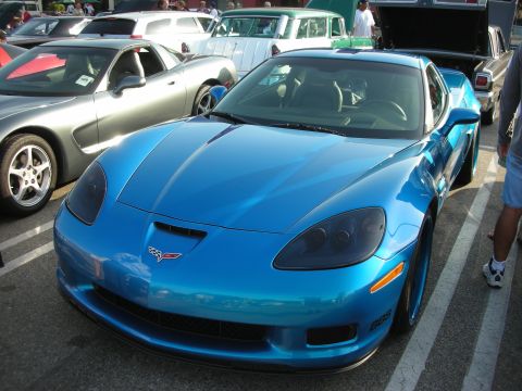 1998 Ford Crown Victoria - A blue Chevrolet Corvette C6 is parked at an outdoor event with other vehicles visible.