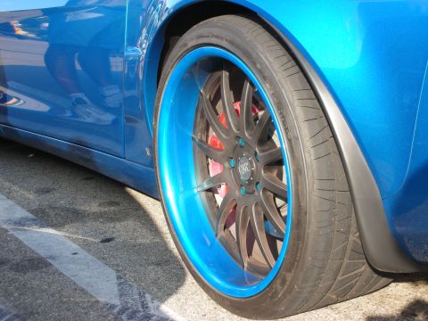 1998 Ford Crown Victoria - The car features custom wheels with a striking blue accent on the rim, paired with performance tires.