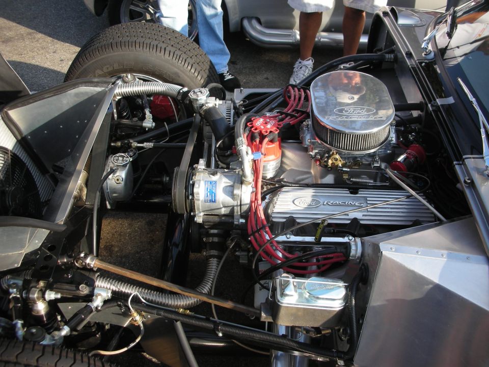 Close-up of a Ford Racing V8 engine with red spark plug wires and a chrome air cleaner