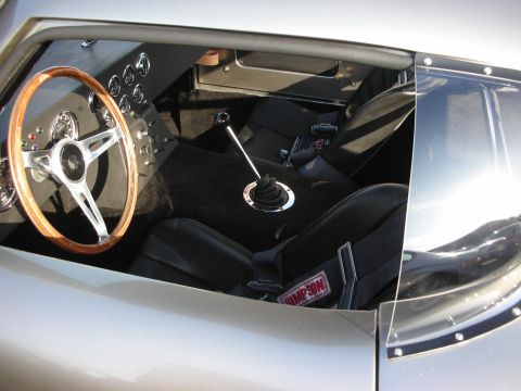 1998 Ford Crown Victoria - Interior view of a classic car with racing seats and a wooden steering wheel.
