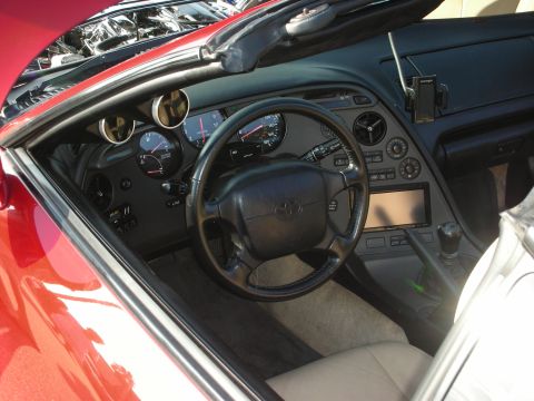 1998 Ford Crown Victoria - Interior of a red Toyota Supra, showing the dashboard, steering wheel, and center console.