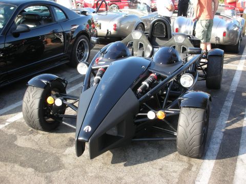 1998 Ford Crown Victoria - Ariel Atom sports car parked at an outdoor gathering with other vehicles.
