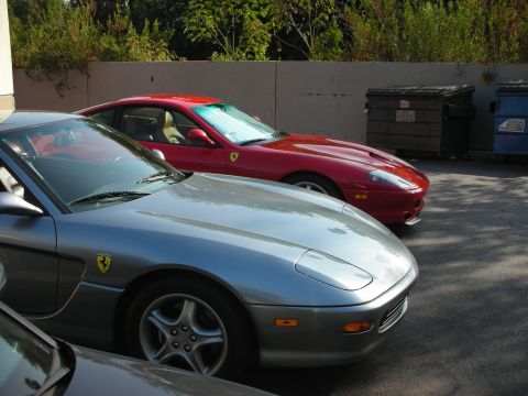 1998 Ford Crown Victoria - Two Ferrari 456 GTs parked side-by-side in a lot.