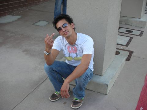 1998 Ford Crown Victoria - A man poses for a photo while squatting on a concrete ledge.