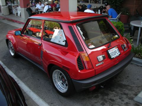 1998 Ford Crown Victoria - A red Renault 5 Turbo is parked outside a cafe, reflecting other cars in its windows.