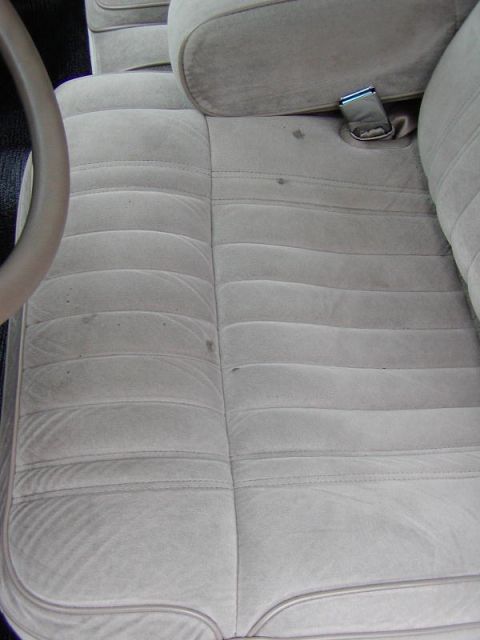 1991 Ford LTD Crown Victoria - Close-up view of the front passenger seat and part of the steering wheel in a vehicle.