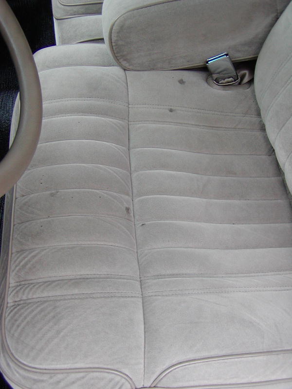 light-colored velour seats and steering wheel inside a car
