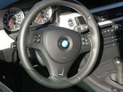1998 Ford Crown Victoria - The interior of a BMW M car features a sporty steering wheel and modern dashboard controls.