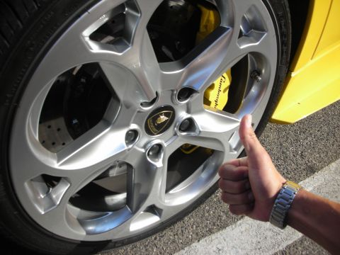 1998 Ford Crown Victoria - Close-up of a silver Lamborghini wheel with a yellow brake caliper showing the 'Lamborghini' name.