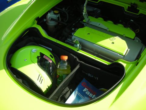 1998 Ford Crown Victoria - Contents of a car's trunk include a helmet, drink, and a racing school magazine.
