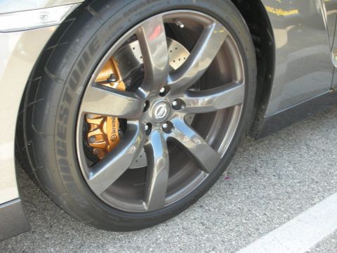 1998 Ford Crown Victoria - A close-up view of a car's wheel, gold brake calipers and a Bridgestone tire.