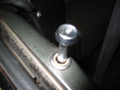 1968 Shelby GT500 - Close-up view of a car's interior door latch mechanism, showing the chrome knob and surrounding metal components.