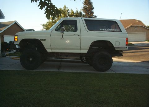 1987 Ford Bronco - Side view of a lifted 1987 Ford Bronco with "Cliff Country" decal on the rear window.