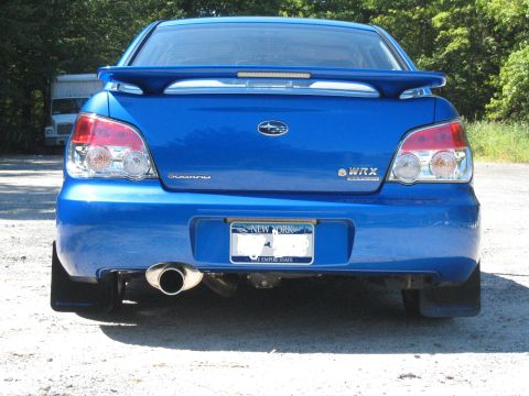 2007 Subaru Impreza - Rear view of a blue Subaru WRX, showing its distinctive taillights, spoiler, and exhaust system.