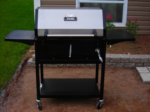 1984 Ford Bronco - A black and silver Broil-Mate gas grill sits on a patio in front of a house.
