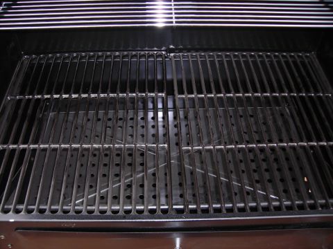1984 Ford Bronco - Close-up view of metal grill grates and the interior of a barbecue grill.