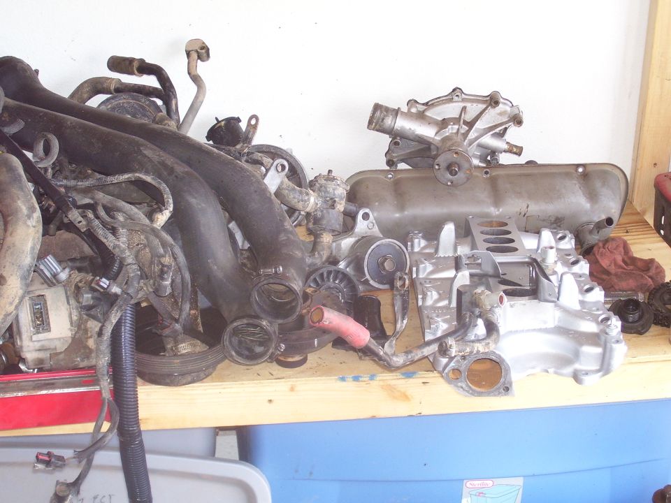 Engine parts including intake manifold, valve cover, and water pump
