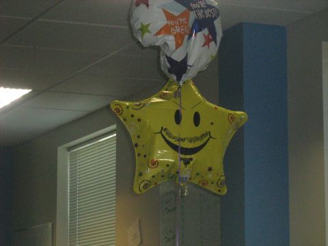 1988 Mercury Grand Marquis - Two balloons are hanging from the ceiling, one is yellow and star-shaped with a smiley face.
