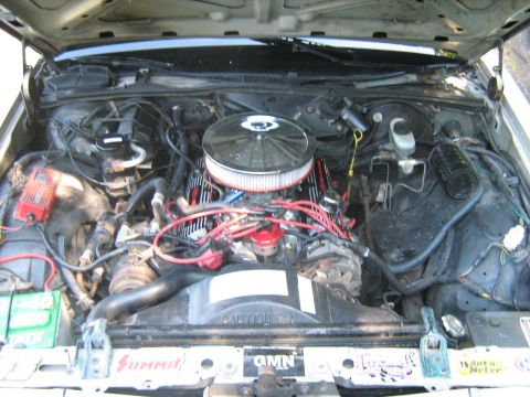 1988 Mercury Grand Marquis - The engine bay of a 1988 Mercury Grand Marquis shows a V8 engine with aftermarket parts and visible branding.