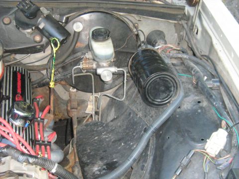 1988 Mercury Grand Marquis - Close-up view of a vehicle's engine bay, highlighting the brake master cylinder and oil dipstick.
