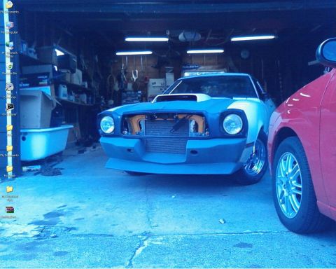 1988 Ford Bronco - Modified car in garage with another vehicle beside it.