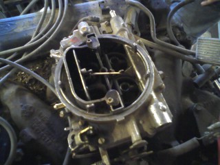 1979 Ford Bronco - Close-up of a Ford 2150 carburetor, part of an engine assembly.