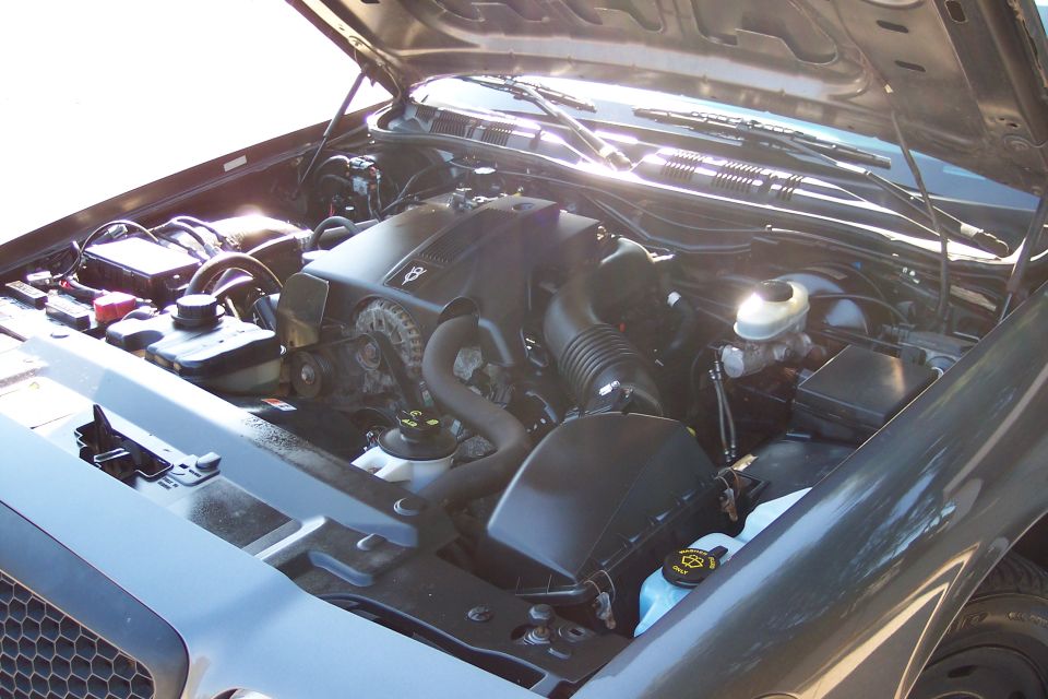 2001 Ford Crown Victoria engine bay with V8 engine, air intake, battery, and brake fluid reservoir visible