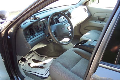 2001 Ford Crown Victoria - Interior view of a 2001 Ford Crown Victoria, with a floor mat stating 'We Make Pride In Your Vehicle!'