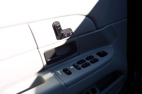 2001 Ford Crown Victoria - Interior view of a car door panel with multiple power controls.