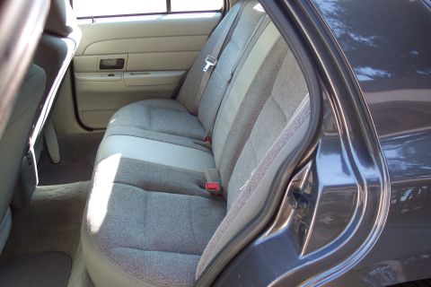2001 Ford Crown Victoria - The interior of a 2001 Ford Crown Victoria shows the rear seats and door panel.