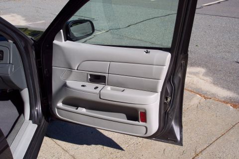 2001 Ford Crown Victoria - Interior view of a 2001 Ford Crown Victoria, showing the driver's side door panel and dashboard.