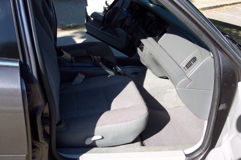 2001 Ford Crown Victoria - The interior of a car is shown, focusing on the passenger side front seat and dashboard area.