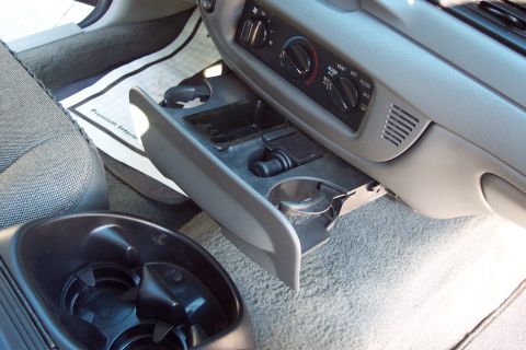 2001 Ford Crown Victoria - The interior of a 2001 Ford Crown Victoria, the center console with cup holders and climate controls.
