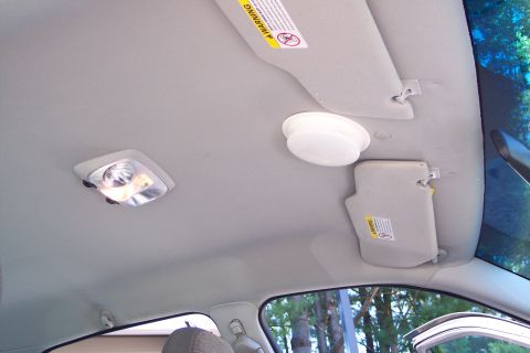 2001 Ford Crown Victoria - Car interior ceiling with dome lights and sun visors visible.