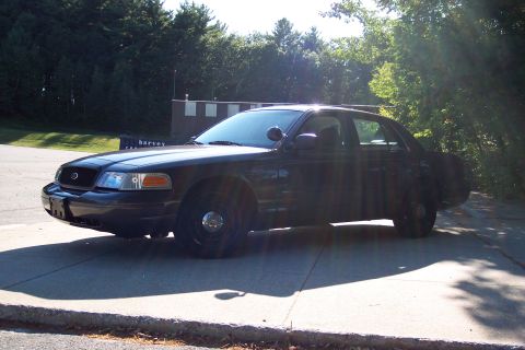 2001 Ford Crown Victoria - Black Ford Crown Victoria police car parked outdoors on a sunny day.