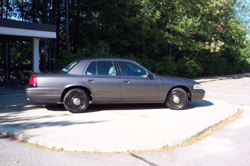 2001 Ford Crown Victoria parked on a concrete pad, side view