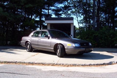 2001 Ford Crown Victoria - This 2001 Ford Crown Victoria sedan is seen from a three-quarter front view, parked outdoors.