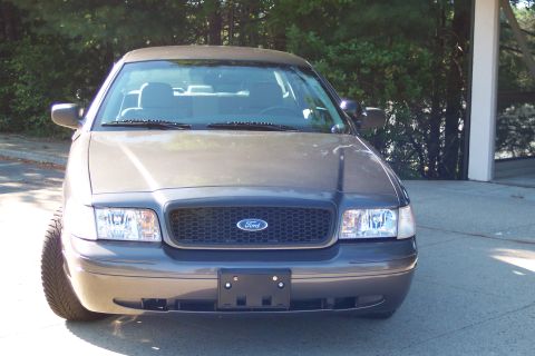 2001 Ford Crown Victoria - This 2003 Ford Crown Victoria is shown from the front, a black grille and clear headlights.