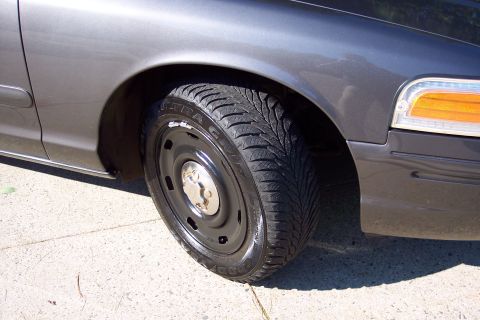 2001 Ford Crown Victoria - Close-up of the front wheel and fender of a 2001 Ford Crown Victoria.
