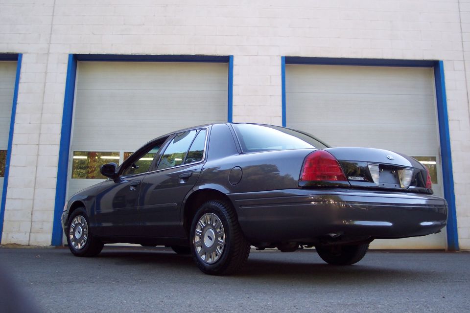 2001 Ford Crown Victoria, rear quarter view, parked in front of garage doors