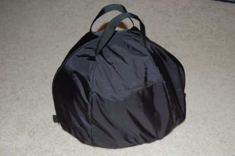 2002 BMW M3 - A black helmet bag with handles sits on a carpeted surface.