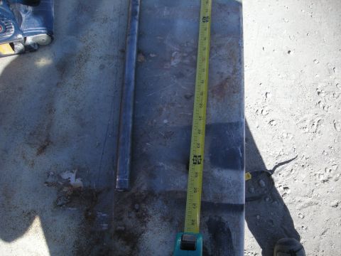 1991 Ford Bronco - Measuring a metal panel with a pipe and a tape measure.